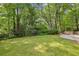 Spacious front yard with lush green lawn and mature trees surrounding the home at 1050 Mountain Creek Trl, Atlanta, GA 30328