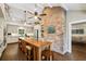 Spacious kitchen with large island, brick column, modern appliances, and white custom cabinetry at 1050 Mountain Creek Trl, Atlanta, GA 30328