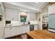 Charming kitchen features white cabinets, stainless appliances, and a view into the dining area at 1050 Mountain Creek Trl, Atlanta, GA 30328