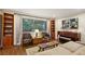 Inviting living room with bookshelves, tufted armchairs, and a large window at 1050 Mountain Creek Trl, Atlanta, GA 30328