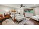 Relaxing main bedroom with a four-poster bed, ceiling fan, and ample natural light at 1050 Mountain Creek Trl, Atlanta, GA 30328