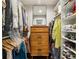 Custom walk-in closet with wooden dresser and mirror and organized clothing racks and shelves at 1050 Mountain Creek Trl, Atlanta, GA 30328