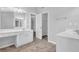Bathroom featuring dual sinks, tile floors, and a walk-in closet at 110 Village Green Cir, Tyrone, GA 30290