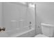 Bathroom featuring a shower-tub combo and a toilet at 110 Village Green Cir, Tyrone, GA 30290