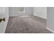 Carpeted bedroom with a double window providing natural light at 110 Village Green Cir, Tyrone, GA 30290