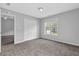 Bedroom with neutral walls, plush carpeting, and a closet and window offering ample natural light at 110 Village Green Cir, Tyrone, GA 30290