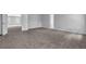 Large bedroom showcasing neutral carpet, bright windows, and open doorway at 110 Village Green Cir, Tyrone, GA 30290