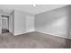 Neutral-toned bedroom with soft carpet, double doors, and entryways to other rooms at 110 Village Green Cir, Tyrone, GA 30290