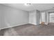 Carpeted bedroom with neutral walls, closet, and entryways to other rooms at 110 Village Green Cir, Tyrone, GA 30290