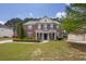 Charming two-story brick home with manicured lawn and lush landscaping at 110 Village Green Cir, Tyrone, GA 30290