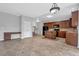Open concept kitchen featuring a central island, tile floors, and a combination of black and wood kitchen appliances at 110 Village Green Cir, Tyrone, GA 30290