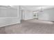 Large living room boasts neutral carpet, paint and an open floor plan at 110 Village Green Cir, Tyrone, GA 30290