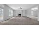 Open floor plan living room with fireplace, built-in shelving and bright natural light at 110 Village Green Cir, Tyrone, GA 30290