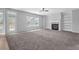 Comfortable living room features a fireplace with built-in shelving and large windows at 110 Village Green Cir, Tyrone, GA 30290