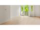 Bedroom featuring ample natural light, hardwood floors, neutral wall paint, and a door to the exterior at 11548 Serenbe Ln, Chattahoochee Hills, GA 30268