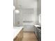Modern kitchen featuring gray cabinets, white quartz countertops, and a wooden island complemented by stainless steel appliances at 11548 Serenbe Ln, Chattahoochee Hills, GA 30268