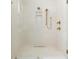 This shower features marble-style tile, gold fixtures, rainfall shower head and built-in niche at 11548 Serenbe Ln, Chattahoochee Hills, GA 30268