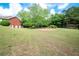 Expansive backyard featuring lush greenery and a well-maintained lawn, perfect for outdoor activities at 1510 Pecan Plantation Ct, Loganville, GA 30052
