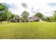 Large, grassy backyard featuring a charming gazebo, a pool, and the house at 1510 Pecan Plantation Ct, Loganville, GA 30052