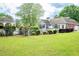 Spacious backyard with a manicured lawn, a gazebo, and an inviting pool at 1510 Pecan Plantation Ct, Loganville, GA 30052