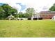 Expansive lawn with gazebo, pool, and view of the house's brick siding at 1510 Pecan Plantation Ct, Loganville, GA 30052