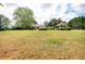 Large backyard with a home and gazebo in the distance on a manicured lawn at 1510 Pecan Plantation Ct, Loganville, GA 30052