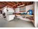 Unfinished basement with pegboard, utility sink, and exposed ceiling at 1510 Pecan Plantation Ct, Loganville, GA 30052