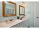 This bathroom has light green walls and two framed mirrors at 1510 Pecan Plantation Ct, Loganville, GA 30052