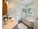 This bathroom has light green walls and a bathtub at 1510 Pecan Plantation Ct, Loganville, GA 30052