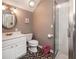 Well lit bathroom with a glass shower and dark patterned tile flooring at 1510 Pecan Plantation Ct, Loganville, GA 30052