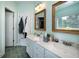 This bathroom has light green walls and a double sink at 1510 Pecan Plantation Ct, Loganville, GA 30052