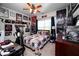 This bedroom has a ceiling fan and a desk with gaming computer at 1510 Pecan Plantation Ct, Loganville, GA 30052