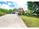 Long driveway leading to a home with a spacious garage and well-kept lawn, offering ample parking at 1510 Pecan Plantation Ct, Loganville, GA 30052