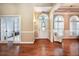 Elegant foyer with hardwood floors, arched windows, and classic finishes at 1510 Pecan Plantation Ct, Loganville, GA 30052