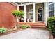 Inviting front porch with classic columns, decorative accents, and well-maintained landscaping at 1510 Pecan Plantation Ct, Loganville, GA 30052