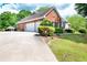 Spacious three-car garage and long driveway leading to a beautifully landscaped home at 1510 Pecan Plantation Ct, Loganville, GA 30052