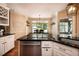 Kitchen with granite counters, white cabinetry, stainless steel appliances, and breakfast nook at 1510 Pecan Plantation Ct, Loganville, GA 30052