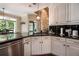 Bright kitchen with granite countertops, white cabinets, and stainless steel appliances at 1510 Pecan Plantation Ct, Loganville, GA 30052