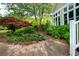 Brick path and meticulous landscaping around the home's sunroom windows at 1510 Pecan Plantation Ct, Loganville, GA 30052