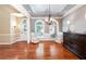 Elegant living room with hardwood floors, chair rail molding, and lots of natural light at 1510 Pecan Plantation Ct, Loganville, GA 30052
