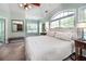 A carpeted bedroom with pale green walls, and big window at 1510 Pecan Plantation Ct, Loganville, GA 30052