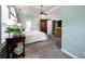 The main bedroom has carpet, light green walls, and a ceiling fan at 1510 Pecan Plantation Ct, Loganville, GA 30052