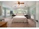 This main bedroom has carpet, light green walls, and a ceiling fan at 1510 Pecan Plantation Ct, Loganville, GA 30052