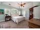 This main bedroom has carpet, light green walls, and a ceiling fan at 1510 Pecan Plantation Ct, Loganville, GA 30052
