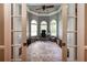 Home office with gray walls, wainscoting, arched windows, and hardwood floors at 1510 Pecan Plantation Ct, Loganville, GA 30052