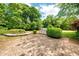Outdoor grill area on the brick paver patio with manicured shrubbery at 1510 Pecan Plantation Ct, Loganville, GA 30052