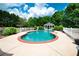 In-ground pool and gazebo surrounded by lush landscaping and fencing at 1510 Pecan Plantation Ct, Loganville, GA 30052