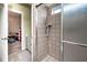 Modern tiled shower with glass doors, showcasing the updated fixtures and neutral color palette at 1510 Pecan Plantation Ct, Loganville, GA 30052