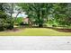 Charming home with a lush front yard, mature trees, and well-maintained landscaping at 1510 Pecan Plantation Ct, Loganville, GA 30052
