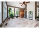 Bright sunroom featuring vaulted ceilings, large windows, hardwood floors and backyard views at 1510 Pecan Plantation Ct, Loganville, GA 30052